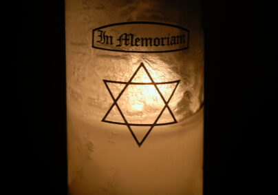 Memorial Candle lit with Star of David on the glass